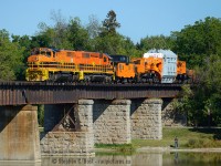 A train that could easily be mistaken as made for each other, or found on someone's model train set. The GWRR orange with the famous HEPX 200 Schabel and rider caboose just look as they are owned by the same company, seen crossing the Grand River at Caledonia. Not the person bottom right for scale.