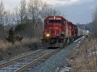 SOO 4410 slowly leads T07 west out of a sag as they approach the Drummond Line on the east side of Peterborough. 1338hrs.