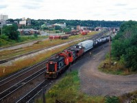 In a scene that has since dramatically changed, consecutive numbered CN SW1200RS units 1360 and 1359 go about their morning duties, switching Hamilton's Stuart Street Yard. 