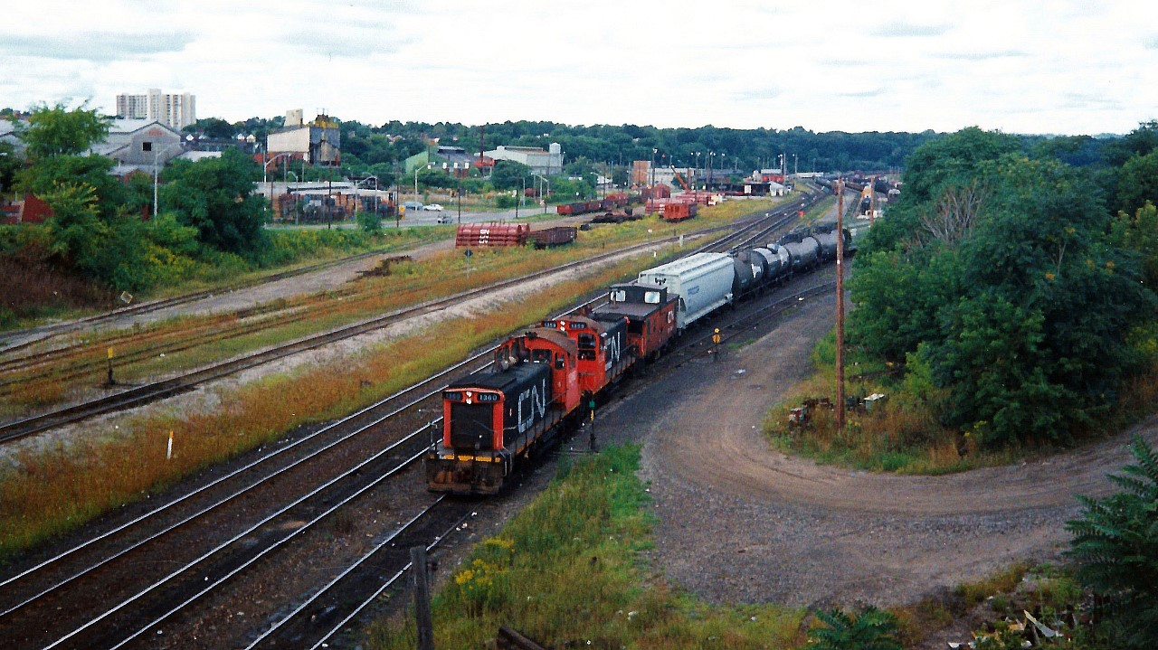 In a scene that has since dramatically changed, consecutive numbered CN SW1200RS units 1360 and 1359 go about their morning duties, switching Hamilton's Stuart Street Yard.