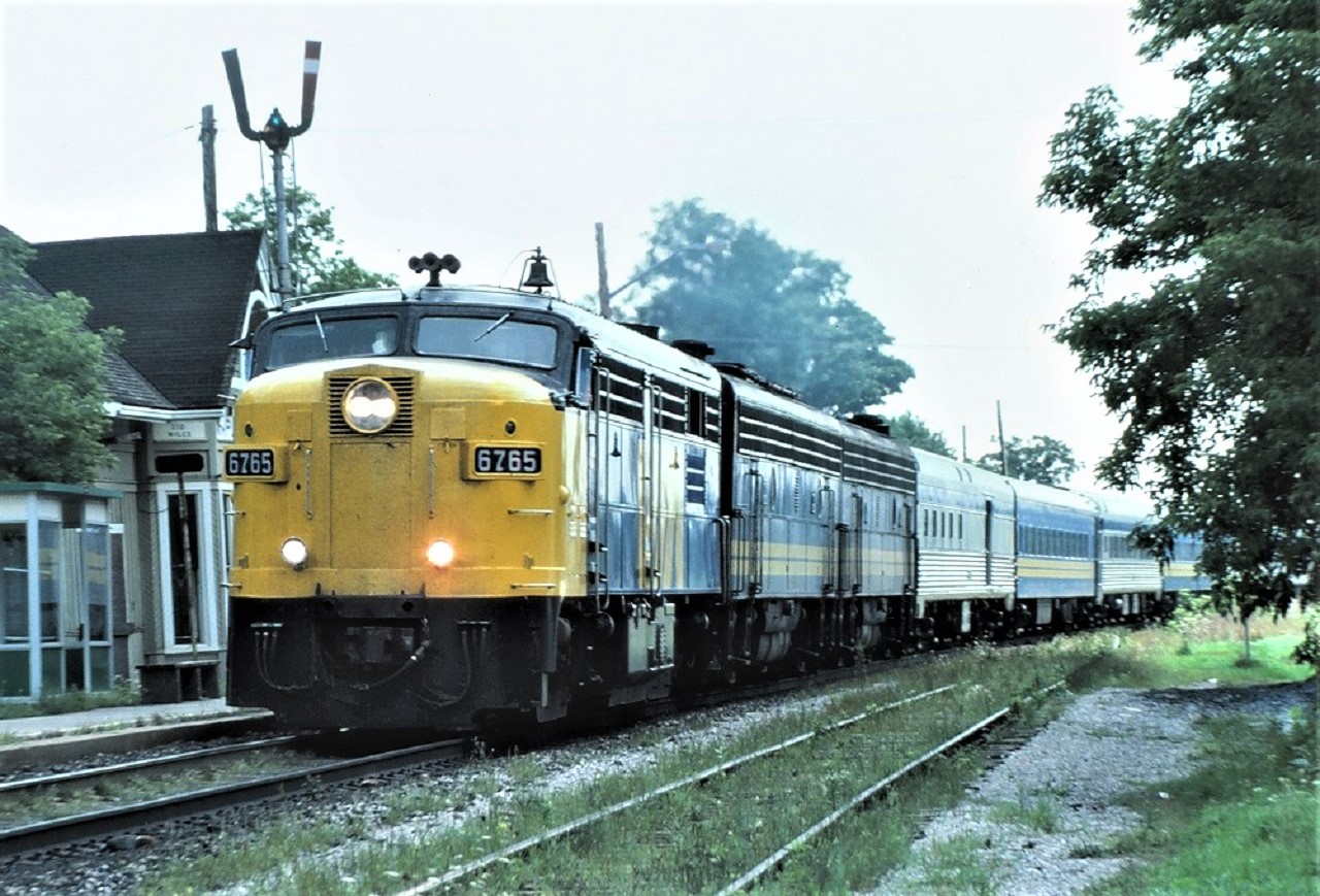 Via Rail's Canadian, train 9, screams past the CN station at Maple, Ontario on Sunday August 17th 1986.  The 11 car train is powered by FPA-4 6765 and a pair of F9Bs 6621 and 6618.  This could have been one of the last occasions where an FPA-4 was leading.