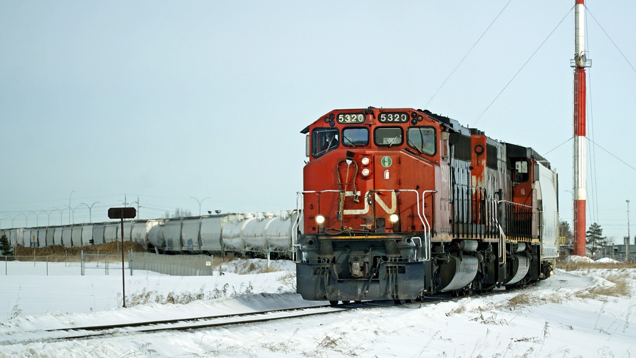 A pair of SD40-2(W)s, CN 5320 and 5268 work on the Fort Sakatchewan Industrial Lead taking hoppers and tanks to the Dow chemical plant.