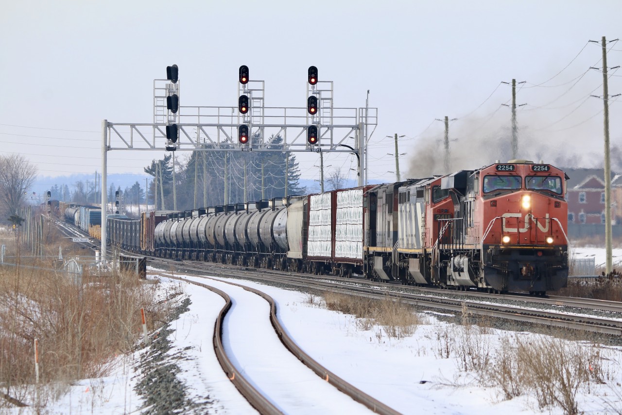 The GO station at Mount Pleasant (control point here is named Norval) offers a bit of a different view even with a bit of clutter thrown in. CN train 570 lately has been a good source for catching soon to be stored Dash-8's. Last week it ran with a full trio of them. Today one of the older GEVO's is up front as the power digs into the slight grade leaving Halton Hills behind them. The two trailing Dash-8's have been assigned to this train for a few weeks now.