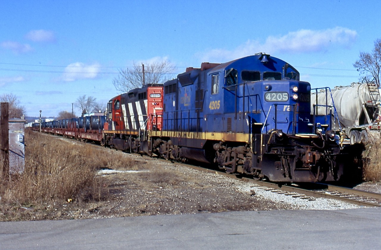This short lived train was kind of interesting. It operated with shared power from both SOR and CN and ran between Hamilton and Nanticoke and return, with steel loads traveling to Hamilton on cars specially converted by CN. I believe union issues eventually killed the train but not totally sure. I'm glad I caught a few times at least. Here the train has left Hamilton yard and is now traveling on the H&NW sour to Stelco to drop the loads.