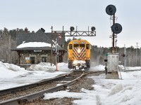 With the sand on, ONR 214 heads South through the mile 71.7 deactivated GRS searchlights next to the restored 1907 Temiskaming and Northern Ontario Railway built depot 