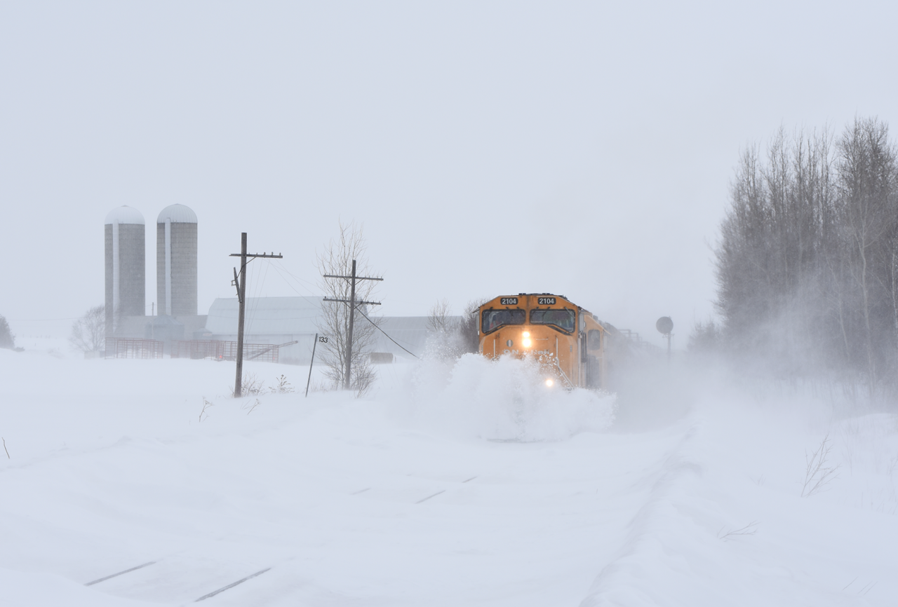 High winds and fluffy snow made for a pretty miserable 10 minute wait, but it was well worth it. ONR 2104 with train 214 to North Bay busts through the heavily drifting snow of the Northern Ontario tundra.