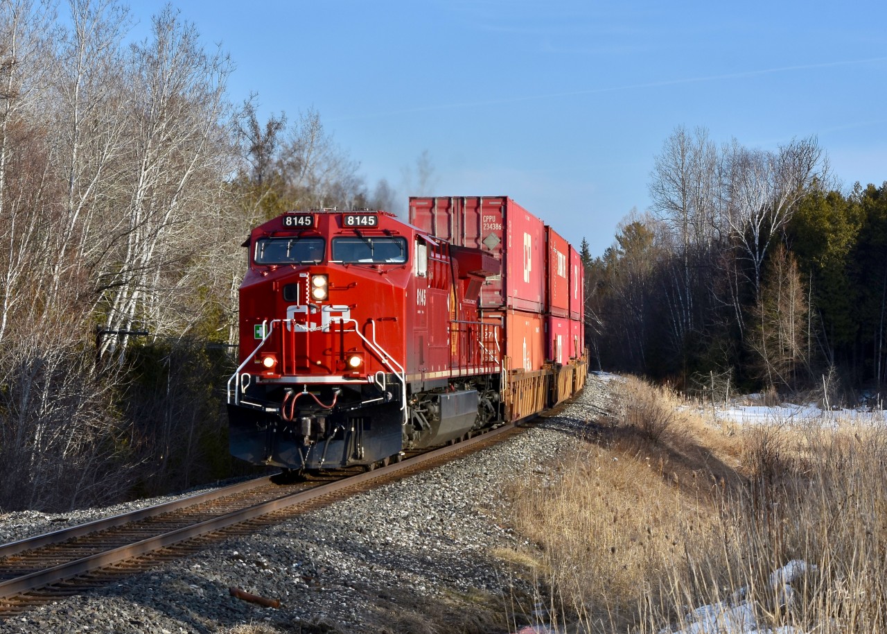 After having just met both southbound trains 112 and 118 in Bolton, a ‘rather later than usual’ CP 113 is back on the move and barrels FAST through some empty farmlands in the eastern side of Caledon as ac4400cw 8145 leads todays Intermodal Northbound up the Mactier Sub up until they reach the northern half of Ontario near Cartier and from there 113 will switch on to the Cartier Sub and follow it ALL THE WAY across Canada westbound until they finally reach 113’s final destination in Coquitlam BC. After about 4 days on the rails.  Time was 17:50 and in this scene the train was approaching Castlederg side road which is only about a mile or so past Bolton. This also happened to be the morning the clocks sprang ahead by an hour so even though I may have lost an hour of sleep, the extra hour of sunlight on this fine Sunday afternoon in March totally made up for it as the stars were able to align ever so perfectly for me to grab this nicely light northbound photo just before the sun began to set and from there it was time for me to call it a day and head home for dinner.