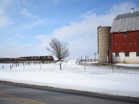 CN L509 rolls through the snow covered hills of Southern Ontario Eastbound for London. With the barn of a family farm alongside the tracks this spot has been a favorite among photographers along the Strathroy sub for over 50 years now. 
