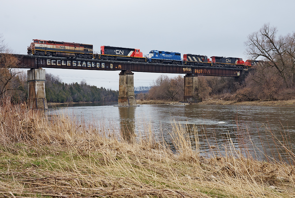 Hodgepodge Of Power


After working Kitchener Yard, a daylight run of CN 533 heads east back to Mac Yard with a hodgepodge of power as seen crossing the grand river.