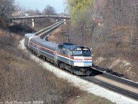 The first run of VIA-Amtrak's joint "Maple Leaf" was on April 27th 1981, but it appears some test runs were done before then. Earlier that month, Amtrak F40PH 339 (bearing extra flags), heads westbound through Bayview on the Oakville Sub with a short Maple Leaf test train consist of two Amfleet cars and what appears to be a business or private car on the tail end. Amtrak 339 was the only unit to bear a small VIA logo on the nose, which only lasted about a year (by mid-1982 it was buffed off). Power-wise, Amtrak F40PH units were staples on the Maple Leaf train for years, including after the former GO Transit GP40TC's began showing up in the late 80's. 
<br><br>
<i>Bill McArthur photo, Dan Dell'Unto collection slide.</i>