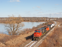 <b>Unit Tank Train on the Humberstone....</b>  Well, sorta but not really haha. The Humberstone spur is a six mile stretch of track extending from <a href="http://www.railpictures.ca/?attachment_id=40058" target="_blank">CN Yagar</a> down to the <a href="http://www.railpictures.ca/?attachment_id=40077" target="_blank">Vale plant</a> in Port Colburne. This little unsuspecting spur packs quite a punch with the 6-axel power handling all the movements for some time now. This neat operation was first brought to light with James Knotts capture of a <a href="http://www.railpictures.ca/upload/running-as-563-crex-1516-and-cn-3019-are-pictured-on-the-macey-spur-just-outside-of-the-vale-facility-in-port-colborne-the-crew-is-switching-ends-for-the-return-trip-to-port-rob-which-provided-an-o" target="_blank">big CREX lessor about to head back to Yagar</a> after serving Vale. Even before this you had cool stuff like <a href="http://www.railpictures.ca/?attachment_id=40170" target="_blank">CP switching Vale as captured by Michael Klauck </a>.<br> <br>

After spending a day in Niagara seeing what was going on, we watched 562 leave Port Robbinson with two chlorine cars on the tail end. After dropping everything but those two cars in Southern Yard, the crew called up the RTC for a “clearance to pass stop at Yagar”, the smoking gun for a Humberstone run. In this shot, CN 2200 and 8001 rolls around what used to be the west leg of the Yagar wye, onto the original Cayuga sub (Air Line) right of way, as I believe. On this particular day, 562 with 8000+ horsepower up front and about 263 tonnes on the drawbar has this one well in hand unless I missed a 20% ruling grade somewhere on the Humberstone.