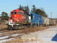 CN L568-13 with GP9RM 4028, GMTX 2323 and GMTX 2279 are rolling through the town of Baden as they head westbound on the Guelph Subdivision to Stratford. All of the cars were later set-off at Stratford for the Goderich-Exeter Railway. The track in the foreground was removed by CN a few months later during the spring. 