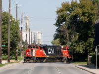 <b>Railfan's worst nightmare.</b> I've heard on multiple occasions that open doors on the front of an engine is a photographers worst nightmare. I never understood this. I don't prefer it, and it certainly doesn't enhance the shot, but I've never minded it to the extend that some fellow railfans do. To me its a reminds me of the rough and tough "get it done" adage that railroading embodies at times; "We don't have air conditioning, so we'll make our own".... Maybe I' just crazy, but I'll let you be the judge of that. <br><br>
Another thing I've heard on multiple occasions is how confusing and annoying Hamilton's streets can be. Many of the roads downtown and in the industrial area are one-way, which can make it tricky to get around quickly. However, driving home from work the one day, I realize I could make an asset out of this. With Wellington being a one-way street southbound, I knew the train would cut off the traffic providing the open view seen above. I like that you can still see <a href="http://www.railpictures.ca/?attachment_id=40525" target="_blank">P&H in the background (the lead to which also crosses Wellington St)</a>, a subtle reminder that I'm standing just outside Hamilton's industrious North End.