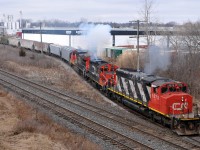 CN 5273, CN 7046, and IC 2710 smoke it up as they shove a dozen hoppers into Normerica on L58031 24