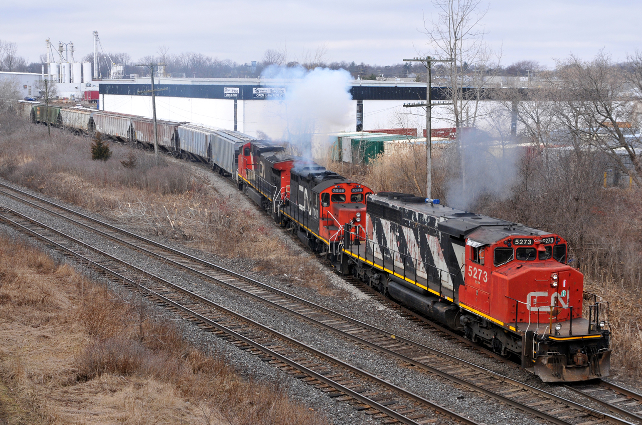 CN 5273, CN 7046, and IC 2710 smoke it up as they shove a dozen hoppers into Normerica on L58031 24