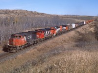 CN 9482,9449,1651, and 4777 lead a mixed train of local cars for Biggar and "old dates" out of Saskatoon yard. This scene changed significantly in late 2019 when CN double tracked this stretch of the Watrous Sub. A keen eye will also note a BCOL caboose 9 cars back.  