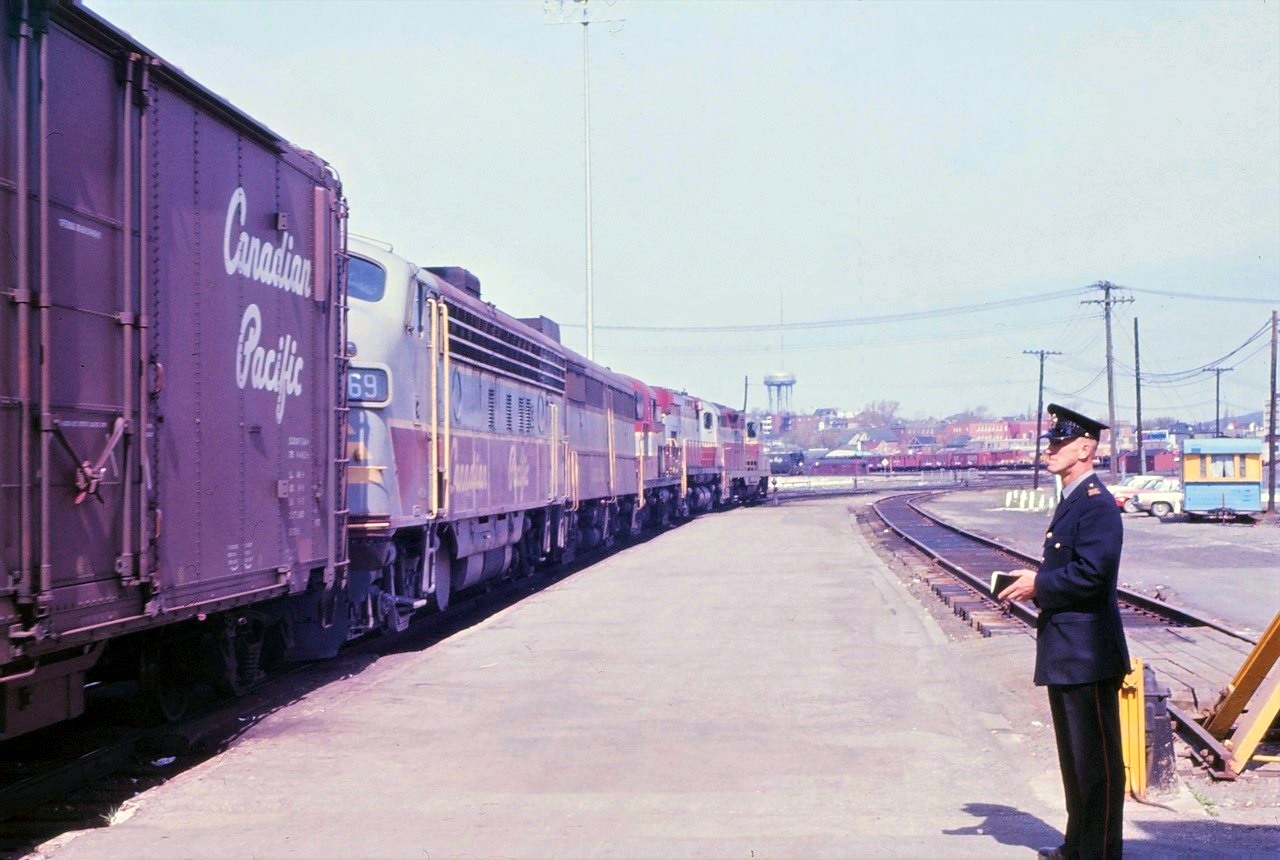 A westbound Canadian Pacific freight passes the Sudbury, Ontario station under the watchful eyes of a CP constable.  I wonder what would happen if I attempted to take the picture under the same circumstances today. Power for the train was classic CP at the time:  from the front:  8639-4221-84xx-44xx-4069.
