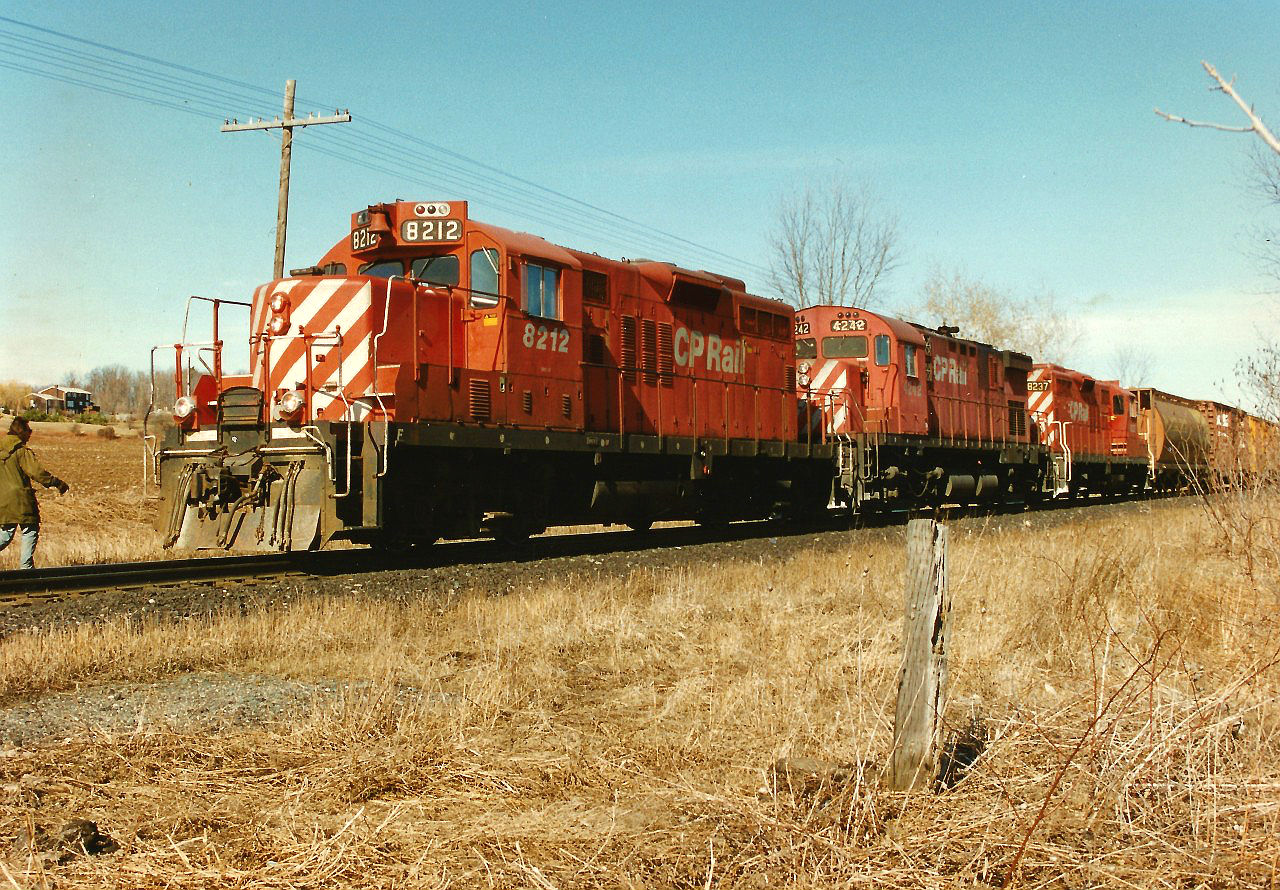 On Good Friday in April 1996, my notes indicate that the Galt Subdivision was busy that afternoon. The conductor of the Hamilton Turn is viewed walking back to his train after activating the switch to enter the east siding switch at Wolverton, just west of Ayr. Here, GP9u 8212, C424 4242 and GP9u 8237 will meet eastbound train 510 before continuing westward to London.
