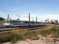 A six-car consist of Calgary Transit C-Train light rail cars is shown at Southland station in September of 1984. These are new German-built Siemens/DüWag U2 light rail cars built for Calgary's C-Train rapid transit system that started up in 1981. Car 2037 on the end is part of an order of new cars built in 1983-84. CP's freight line is visible in the foreground.