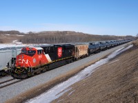 In a what can easily be described as a very "clean scene" CN 3893 brings up the rear of a loaded crude oil train while meeting a loaded GrainsConnect westbound on the recently completed stretch of double-track between Biggar and Newton. 