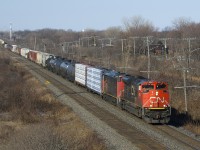 CN 8934 & CN 2432 lead a 126-car CN 322 through Beaconsfield. After setting off cars in Taschereau Yard, this train will terminate at Southwark Yard.