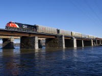 Brand new ET44AC CN 3273 has 105 empty autoracks on the drawbar as it leaves the island of Montreal.