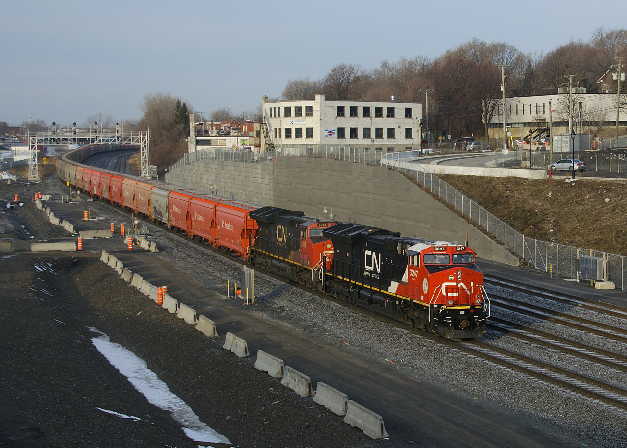 Loaded potash train CN B730 is slowly approaching Turcot Ouest where it will change crews. This heavy train has 205 cars and CN 3247 & CN 3012 up front, CN 3876 mid-train and CN 3002 on the tail end.