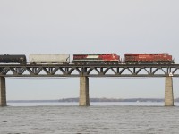ES44AC's from a Canadian and a Mexican railway (CP 8955 & FXE 4609) are on a train that originated in the U.S. (CP 253) as they cross the St. Lawrence River.