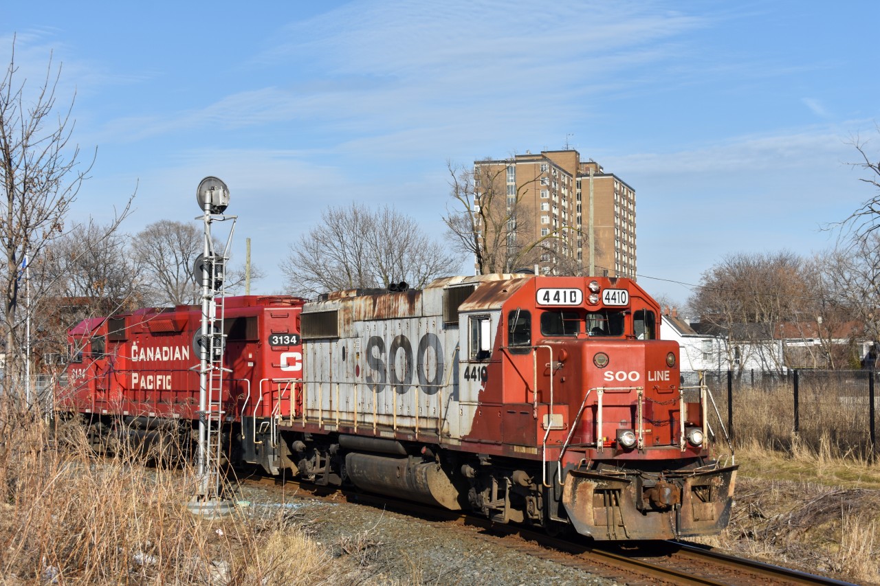 SOO 4410, along with CP 3134 is curving southwest on the Mactier Wye at West Toronto, running as train T15. Apparently, the trailing unit (which was leading west at the time) had issues when the crew was working the West end of Lambton Yard, so they decided to wye the power in order to have 4410 facing west. Hearing this on the scanner as I was hanging out near the old stockyards shooting Milton GO trains, I knew I was in for a treat. I scrambled over to some nice searchlight signals on the connecting track from the Mactier Sub to the Galt Sub, and set up. As far as I know, the only trains that use this track on a weekly basis are 235 (Spence to Windsor), and some CN-CP transfers, both of these happening in basically pitch dark, so I was even more excited to see something else use it, especially in almost perfect lighting. I'm not usually happy to hear when a unit has issues, but considering the result of this one I can't say I'm unhappy at all.