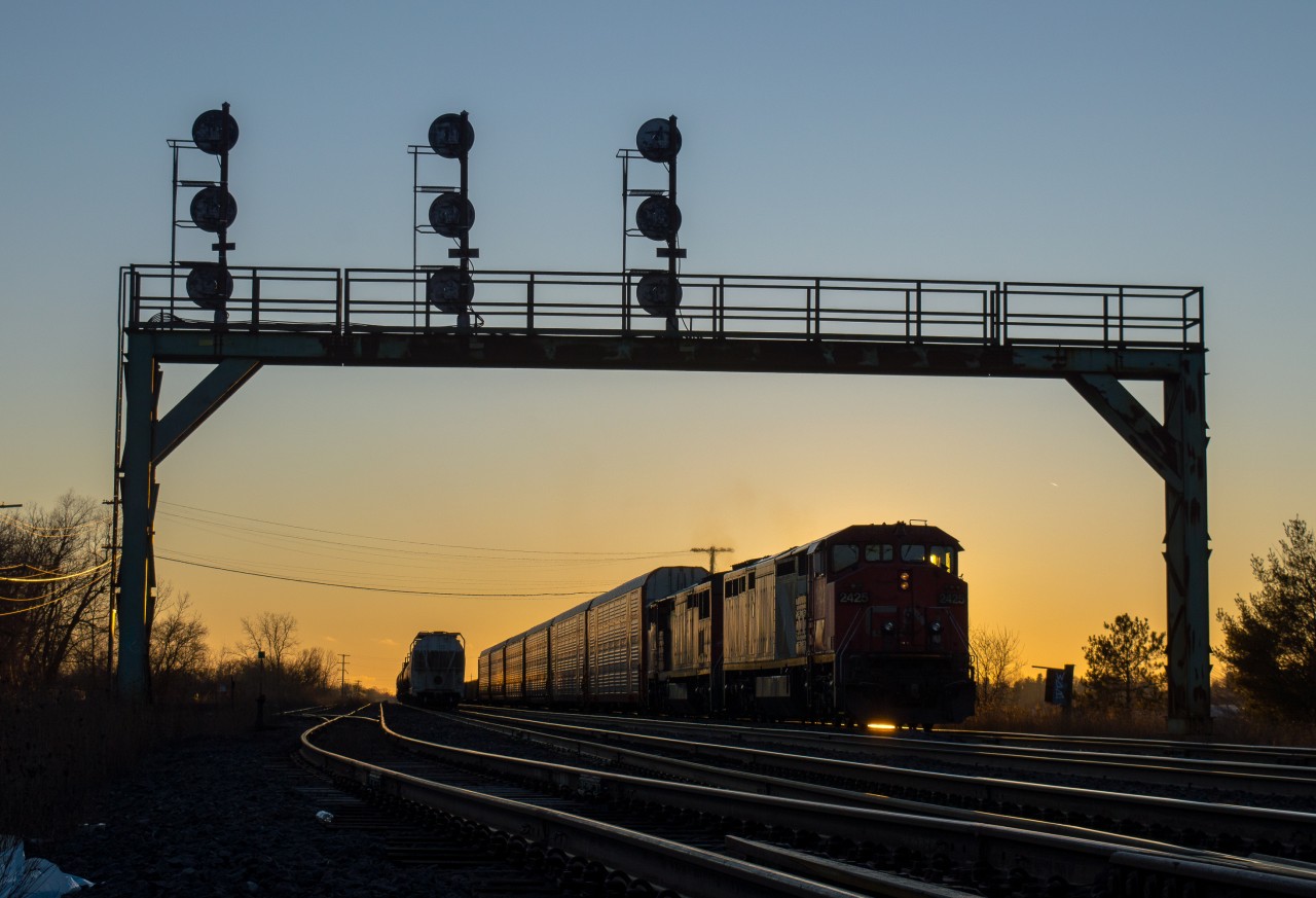As the sun begins its final descent of the day, CN 434 begins its work at Paris Junction behind a pair of GE C40-8M's.  In the last year, CN has become saturated with GEVOs so a pair of cowls was a nice change of pace.  Rumour has it that the cowls are running on borrowed time, the setting sun could serve as a nice metaphor in the near future...