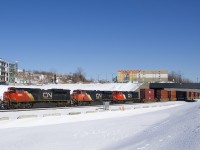 A very late CN 121 is about to cross over from the north to the south track after letting CN 324 pass on the south. CN's Montreal Sub has four tracks here, but three were being used to park trains. Power is CN 8883, CN 2225 & CN 8876.