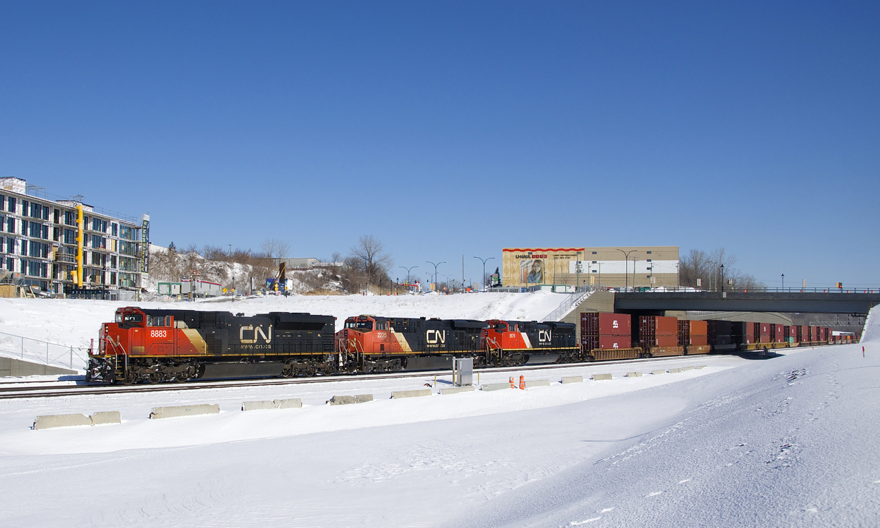 A very late CN 121 is about to cross over from the north to the south track after letting CN 324 pass on the south. CN's Montreal Sub has four tracks here, but three were being used to park trains. Power is CN 8883, CN 2225 & CN 8876.