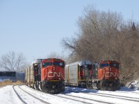 Solid autorack trains CN X276 and CN 276 are parked on CN's Montreal Sub, both led by SD75I's. Out of sight between them is a third parked train, CN 306. CN X276 has CN 5679 & CN 5613 for power, while CN 276 has CN 5707 & CN 2665. CN 276 normally terminates in Ontario, but both of these trains will eventually head to Joffre yard near Quebec City.