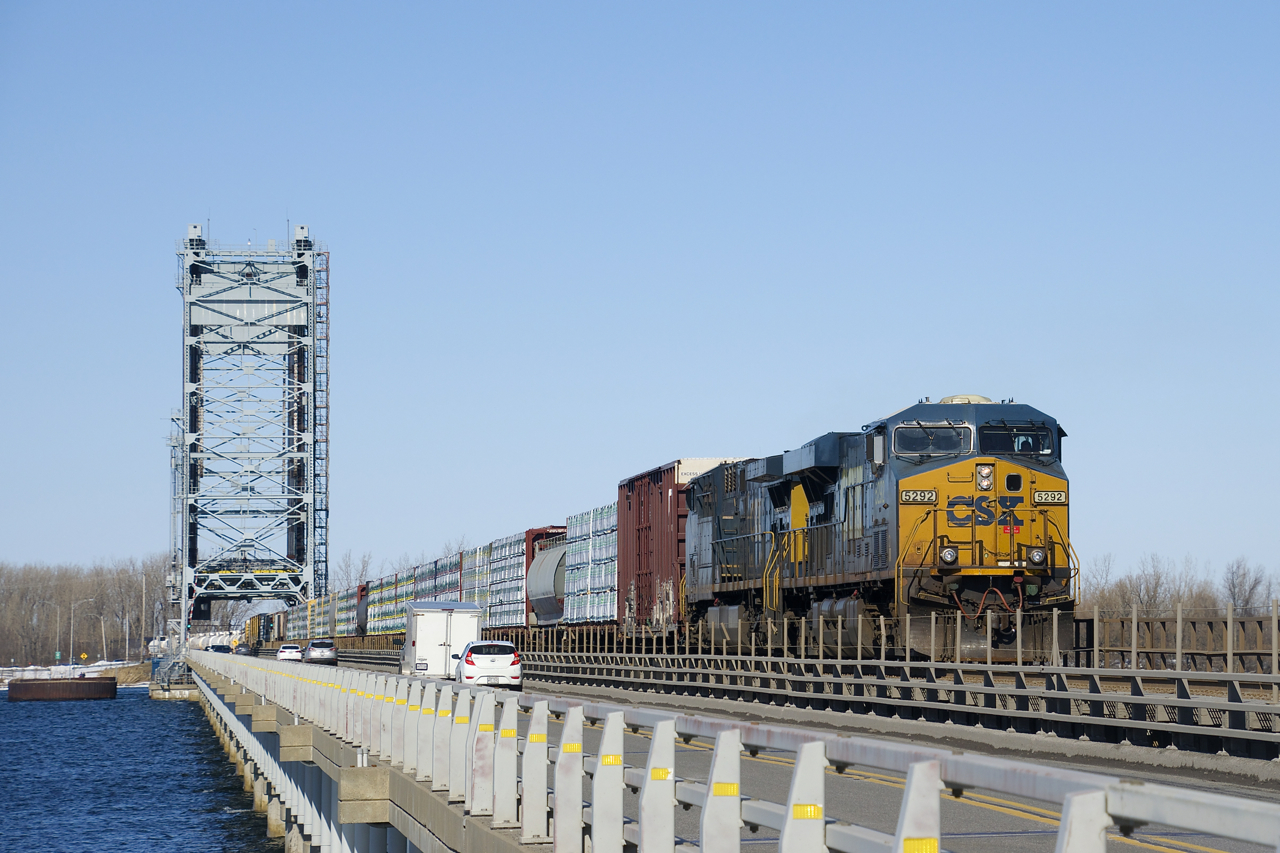 CN 327 with CSXT 5292, CSXT 414 and 81 cars is crossing the Larocque Bridge over the Beauharnois Canal, which the CSX track here shares with Route 132.