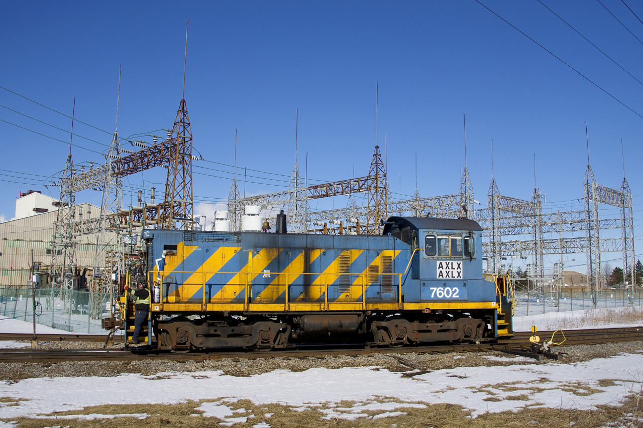 Ex-Port of Montreal SW1001 AXLX 7602 is about to head back towards the Axiall Canada Inc. plant once the switch at left is thrown. The track at right is CSX's Montreal Sub.