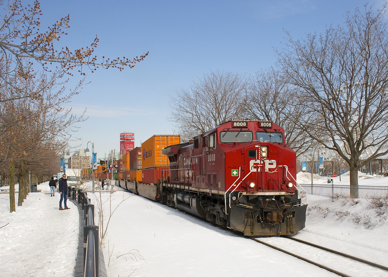 CP 118 with CP 8008 has temporarily advanced onto CN's Wharf Spur (presumably for headroom) and is stopped, blocking a couple of crossings. After a 15 minutes or so wait it will back up towards Port of Montreal trackage.