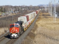 A very late and a very lengthy CN 121 (205 platforms) approaches MP 14 of CN's Kingston Sub with CN 3102 up front and CN 2966 mid-train on a windy afternoon.