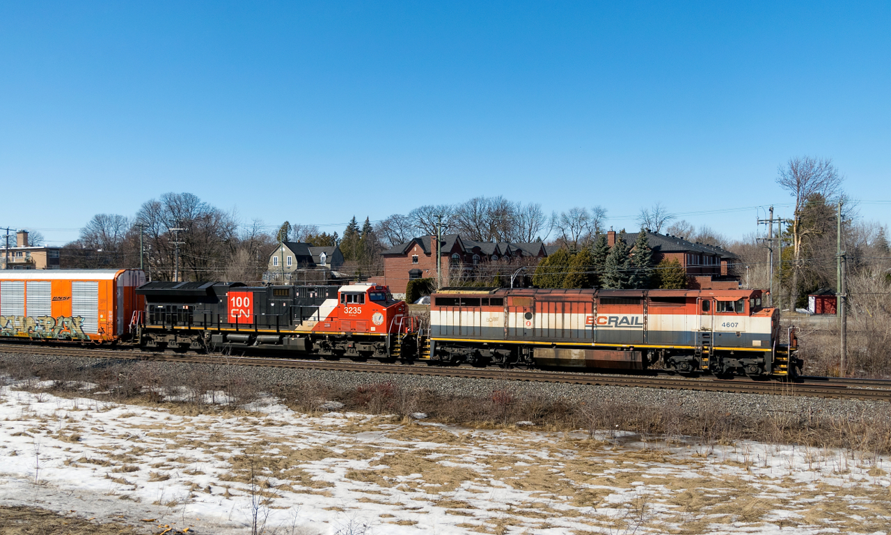One of only eight BC Rail cowls that is still active leads CN X276 on CN's Kingston Sub, with relatively new CN 3235 trailing. With CN 276 just ahead of it and congestion in Taschereau Yard, it would be held out for a couple of hours.