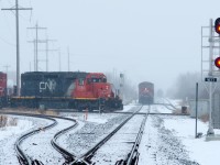 When the weather outside is frightful... the trains run like streetcars!  CN 5386 pounds the diamond at East Edmonton while an empty CP crude train waits to pull across, then back into the Kinder Morgan terminal at left. 