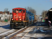 My wife and daughter look on as CN L568 departs Kitchener westbound with hoppers for Shakespeare, passing the station with CN 1439, GMTX 2279 and GMTX 2289.
