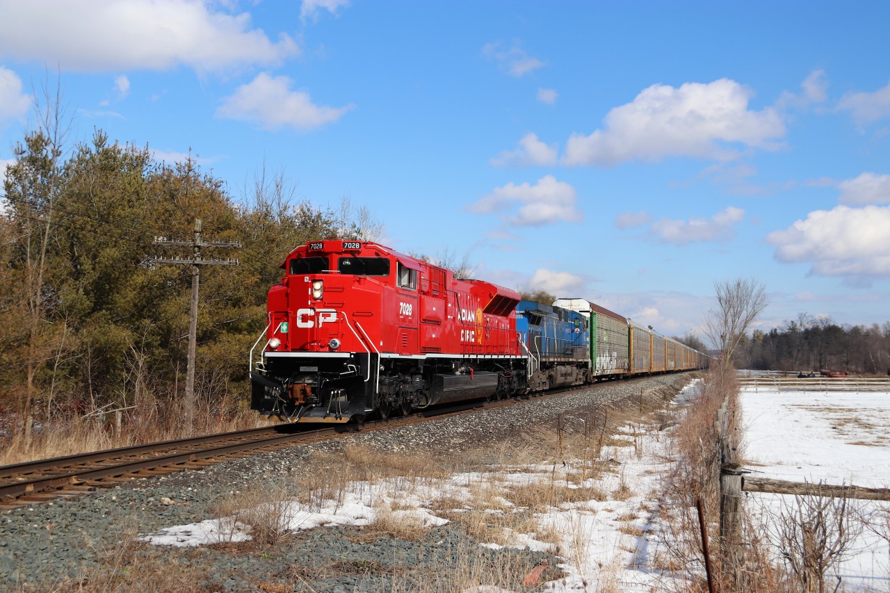 My grandson wanted to see a train that goes fast so off we ventured to try and catch a CP 651 we thought was coming. We were just approaching Moffat and my phone started going off steady but I was driving and couldn't answer. We got to the Conservation authority driveway and that's when I read about this guy. The sun is perfect, the train is good, the company is even better. CP 147 with SD70ACu CP 7028 and CEFX 1055 for power, accelerate out of Guelph Junction past Mountsberg with their load of auto racks headed to Wolverton. Even the horses stopped for a look.
