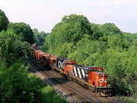 The shadows are beginning to grow long thus late spring day as a CN ballast train led by GMD1 1430 rolls into Bayview junction. The train will soon use the wye so it can face the opposite direction in order the drop ballast on the north track as they head for Aldershot.  