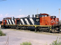 In the early 2000's the GMD1'S were still pretty rare in eastern Canada. Not long before I took this photo GMD1'S 1430 & 1431 arrived in Toronto. The pair had previously been assigned to the prairies and their light weight branchlines. The fresh paint and number on 1431 is due to its recent renumbering from 1601, at the same time it lost its distinctive six axle A-1-A trucks. 1430 was previously 1600. This pair spent decades serving the network if prairie branchlines and sadly helped disassemble many of the same line just prior to heading east. The pair is seen in Oakville yard preparing a transfer job that will next head to Aldershot yard. Unfortunately the pair was retired a number of years ago but luckily a free other GMD1's have since taken their place, although their numbers are shrinking fast. 