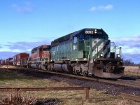 The Hunter Harrison years are not fondly remembered by most railroaders, but for railfans it meant just about anything could show up on trains as his "Precision Railroading" basically meant get the trains over the road as quickly as possible with whatever power was available, even if it meant bending the rules a lot. Case in point this day was train 394 with a First Union ex BN SD40 on the point with no Canadian approved appliances in the cab. It wasn't long before the union stepped in but there were still the occasional exception that slipped through. This day train 394 rolling through the small town of Lynden. The old abandoned junction to the "Brantford bypass" is in the distance beyond the curve. It once ran straight from here to Paris with another junction at Harrisburg for the line north to Galt. Today this is all abandoned although when I took this shot a stub track still remained at the junction for car storage.  The abandoned station grounds too are in the foreground and a weed covered track here once served to co-op. 