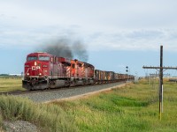 After an eastbound potash train cleared, CP 851 came out of the hole at Boharm with 11,000 feet of ballast empties in tow. With the pair of SDs trailing and my evening being entirely open, I gave chase and booked it through some pretty wet and saturated grid roads (the kind where I worried if I slowed down I'd end up stuck) on the way to the Trans Canada Highway, and headed west and <a href="http://www.railpictures.ca/?attachment_id=38885" target="_blank">caught up with them in Mortlach</a>, where the sun had reappeared and they were again going in the hole to let four other trains pass. Safe to say 851 was pretty low on the pecking order for RTC.
