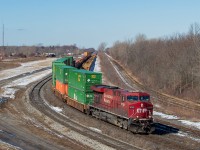 Another <a href="http://www.railpictures.ca/?attachment_id=40484" target="_blank">late 143</a> is pictured here passing through Fort Erie in the final moments before entering the International Bridge and into Buffalo, NY where it will be handed over to CSX crews. 143 has <a href="http://www.railpictures.ca/?attachment_id=40462" target="_blank">occasionally been running with mid-train DPUs</a> lately, and you can see CP 7014 (heritage unit) awkwardly in the middle of this train some nine wells back. I can only assume they set off quite a number of cars in Toronto earlier that morning, otherwise I struggle to comprehend this power arrangement. <br.<br>You can see some well cars in storage again in Fort Erie, and later in the day X149 brought down more and placed them onto Track 99 (pictured furthest right).