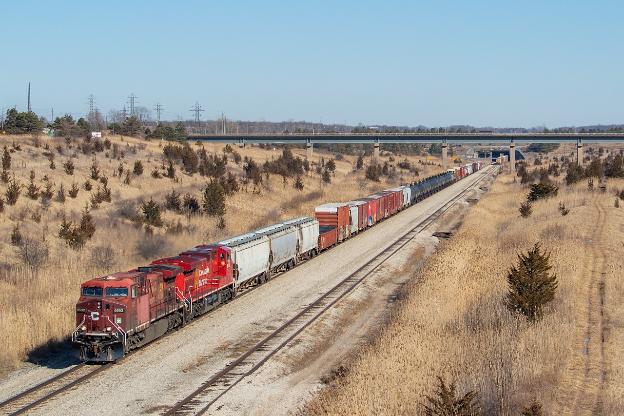 The pride of the fleet, CP 9592, leads a 54 car 255 through the Welland Canal tunnel cut on its way towards Welland, Hamilton, and London. This is an angle that comes and goes with movements of racks in and out of storage on the pictured Rusholme Siding. As recently as February, Rusholme was completely void of any racks in storage. Now, many are back, extending from the east end of the siding to just poking out of the west end of the tunnel under the Canal, as pictured. At times, they will stretch much further west than this. I shot a train on the other side of the Canal back in May 2019, and you can see how the racks effect the angle here.