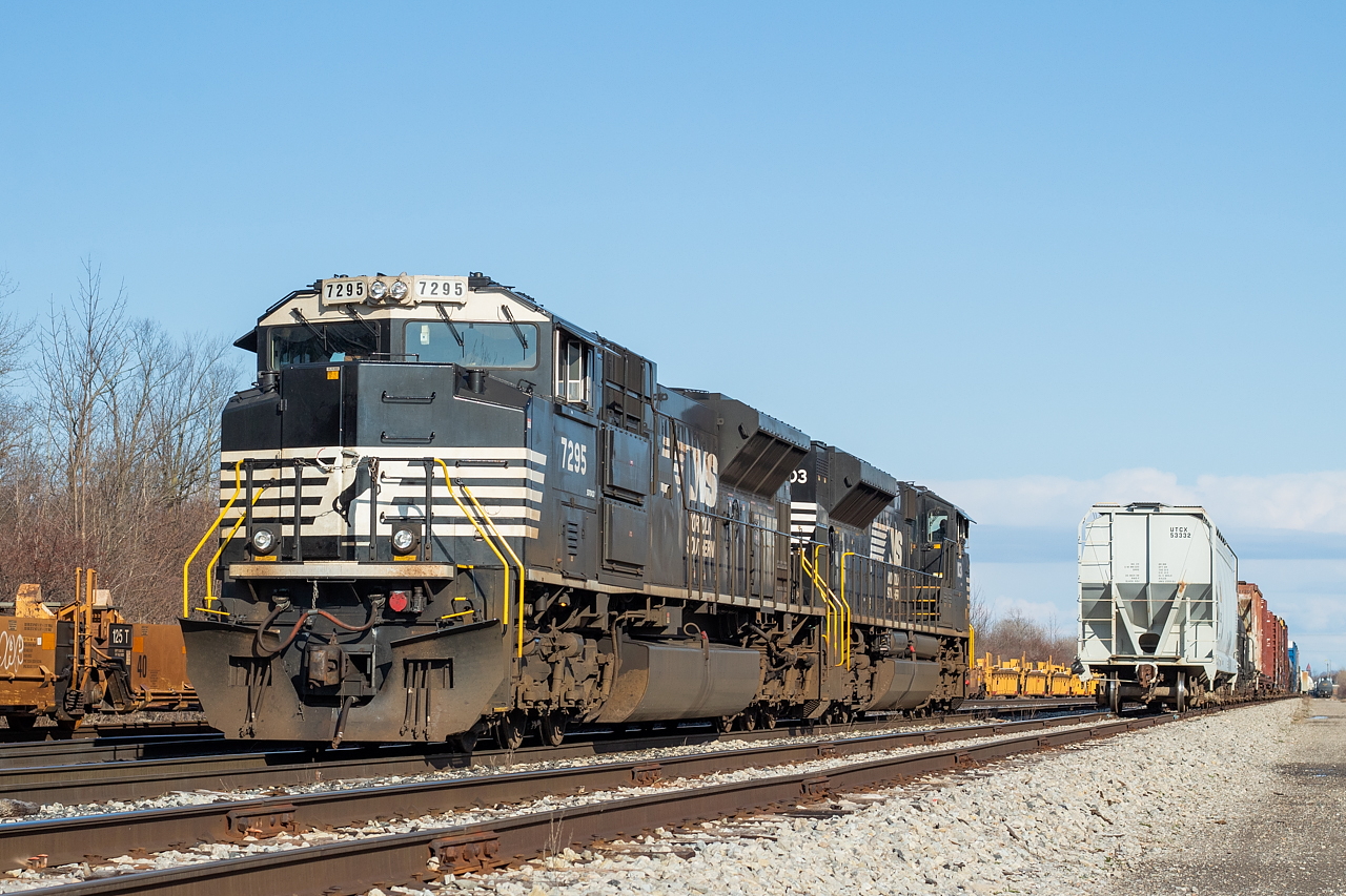 The daily NS transfer with NS 7295 and NS 1103 has set their train off for CN, pictured at right, and have switched ends to go pick up the set off from CN 531 before heading back over the border. By this point, 531 had just crossed into Buffalo.