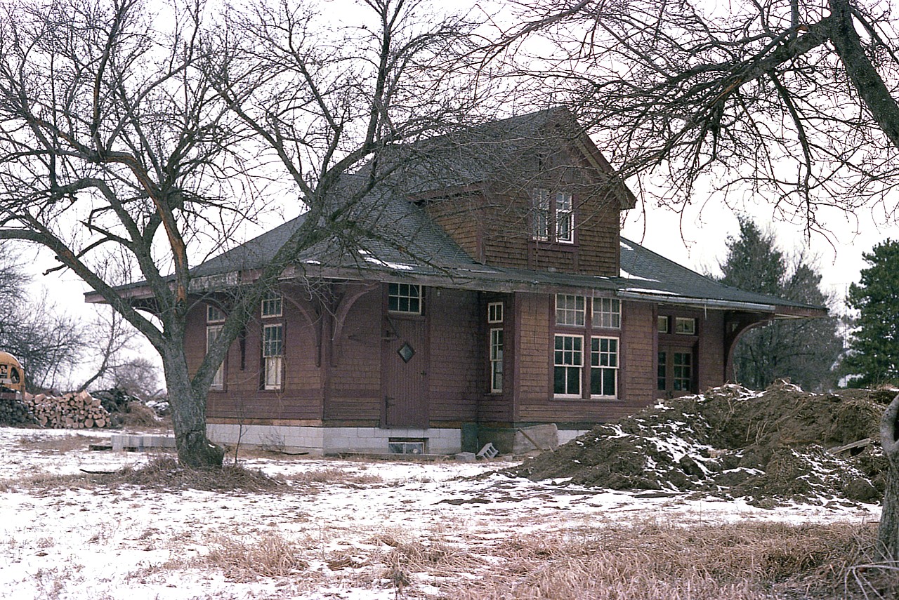 As much as this old Lake Erie & Northern electric Rwy (later Grand River Rwy) station looks like it has begun life anew as a private residence; this photo is old enough that things have changed. The building, constructed in 1916, has been privately owned since 1978 and upon its new foundation as you can see in this very early 1980 image.
Time has moved along and the station was abandoned and barely made it thru this past winter without collapsing.
To the rescue comes the Brant Railway Heritage Society, and they have stemmed the tide of decay and are determined to restore the building, if possible. An exact replica using original hardware might be the only way to salvage, as the structure was in terrible shape. However, as this is posted, restoration is an active concern. Work parties are tackling the project.
Volunteers are needed: One can go to facebook and look up Brant Railway Historical Society for information.
Needless to say, cash donations will also go a long way.
The structure is a CP #14 standard station. If restoration is completed as planned, this building might be on the move once again.