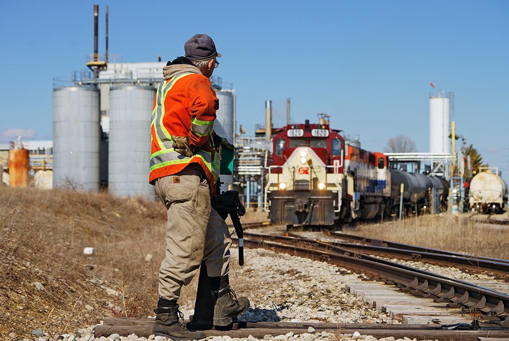 Brakeman Steve Bratina mans the switch at AOC looking onward as the conductor makes the joint on a loaded maleic acid tank car.